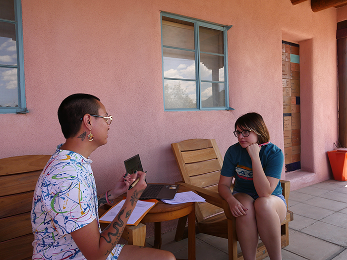 students sitting outside talking at the Doel Reed Center