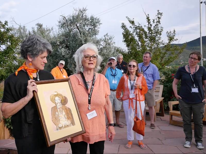 Dr. Carol Moder with framed art piece